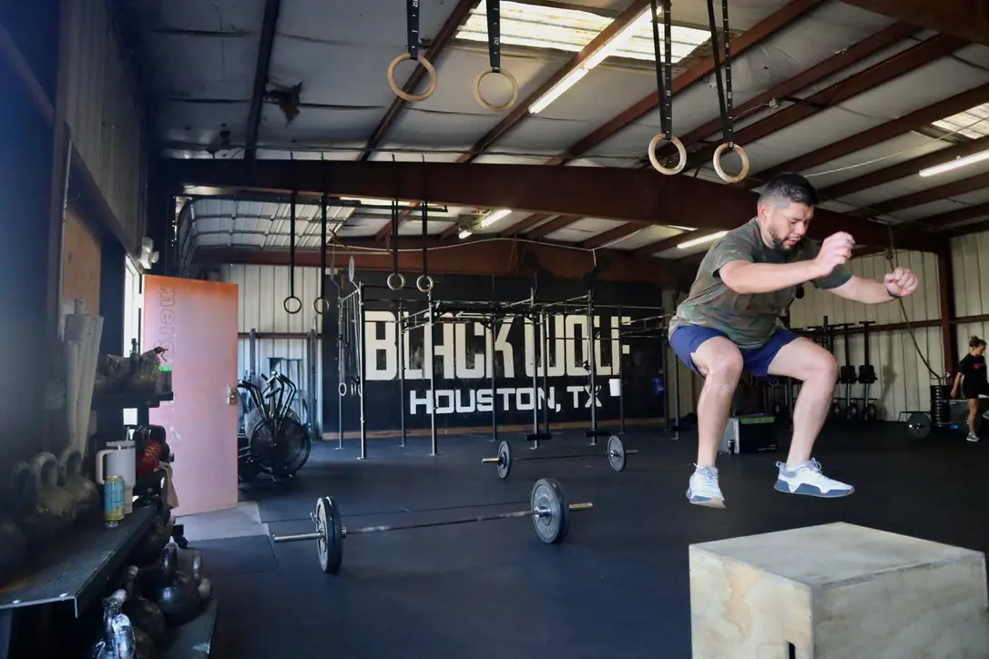 Member box jumping in front of the Black Wolf Houston wall