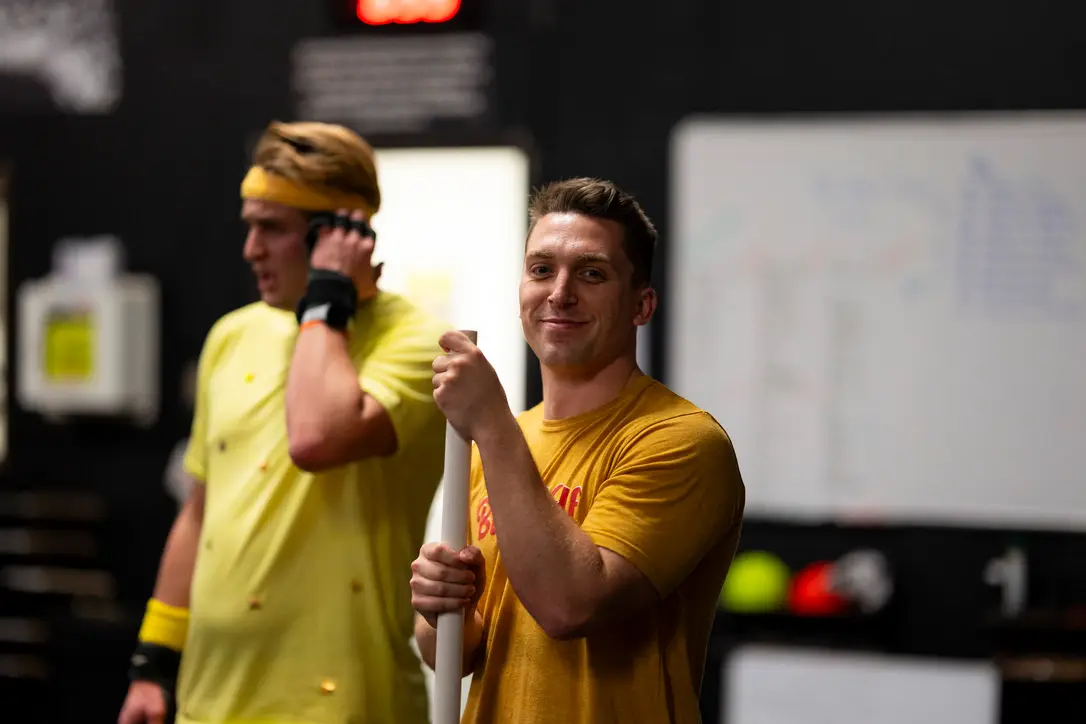 Two members smiling during a partner workout