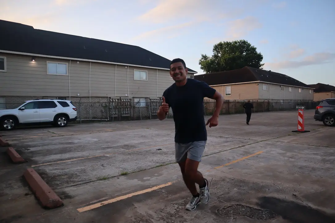 Black Wolf member smiling mid-run outside the gym